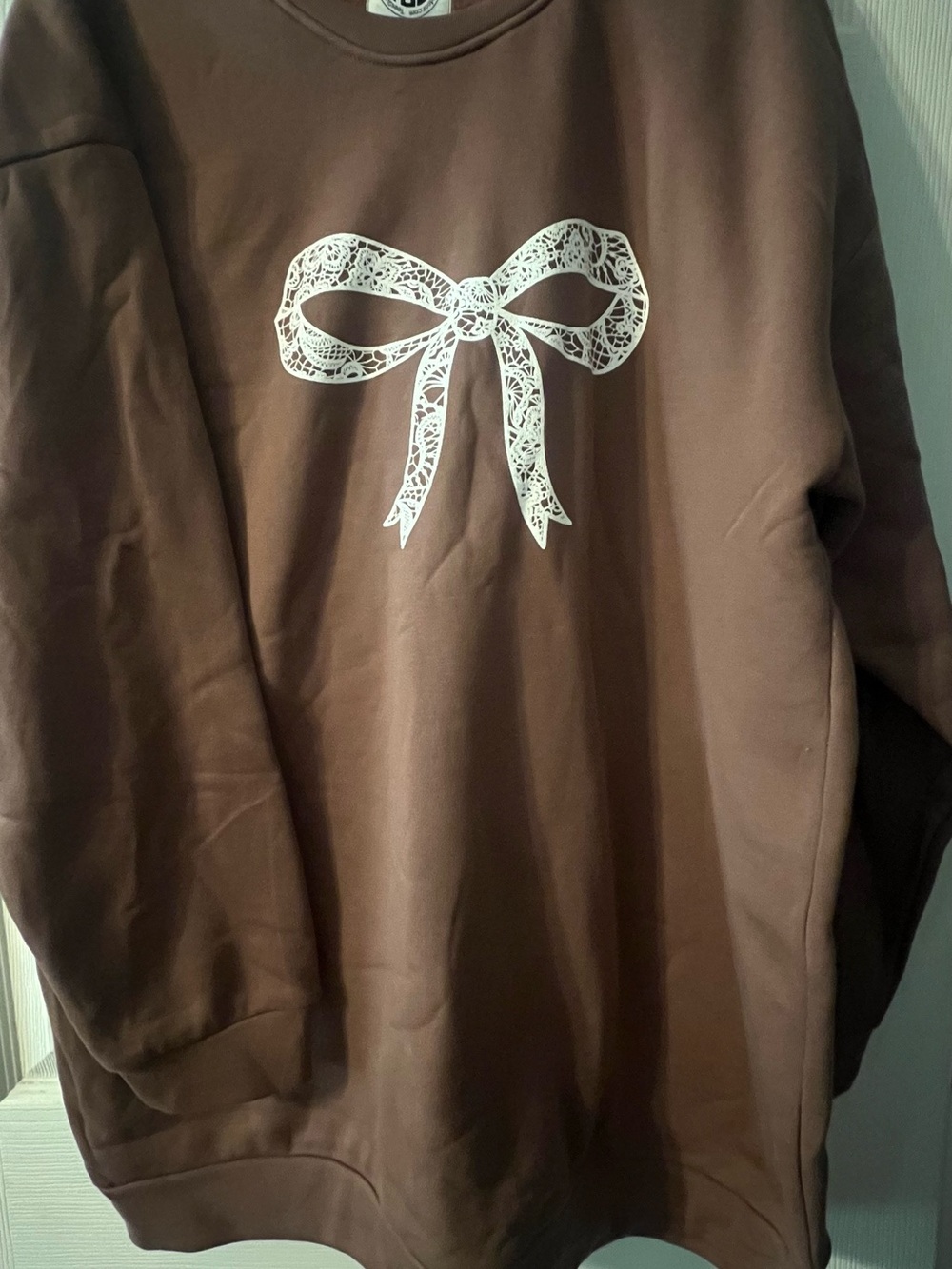 Brown Crewneck Sweater with White Bow Graphic